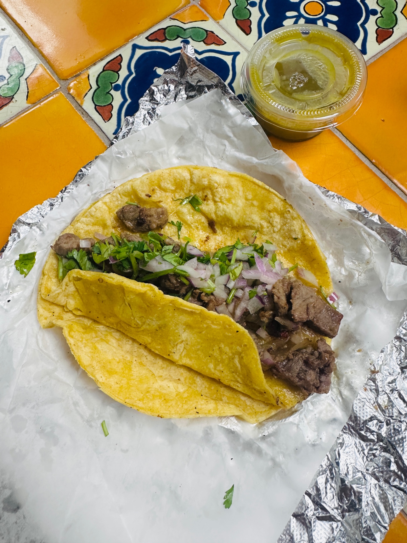 Three breakfast tacos with eggs, chorizo and salsa